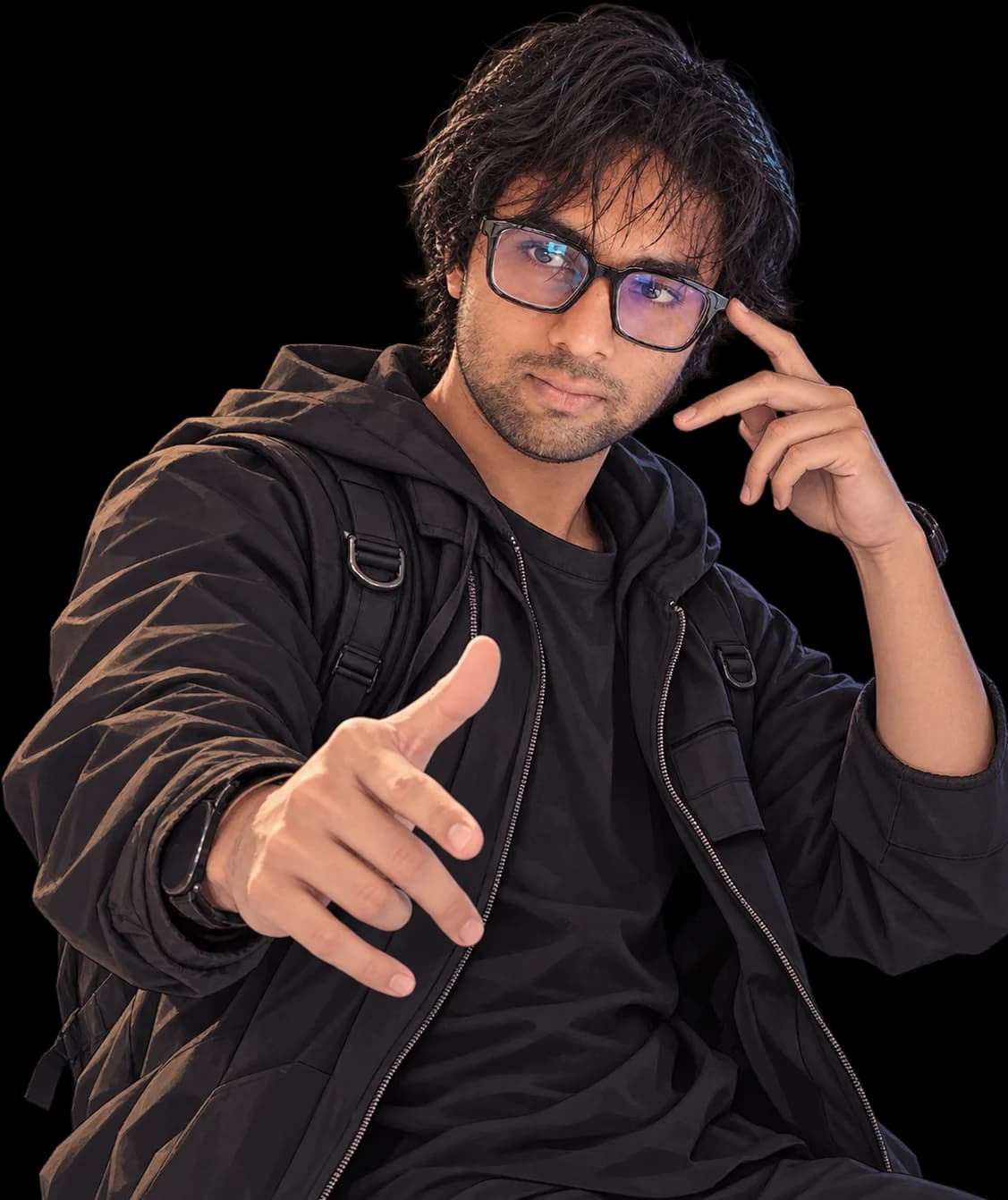 Tasdid Hosain in a black jacket, adjusting glasses and pointing at the viewer